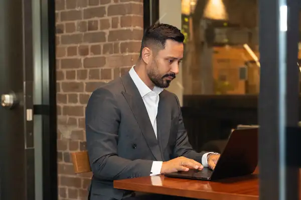 Business professionals exchanging professional indemnity insurance documents in a corporate boardroom