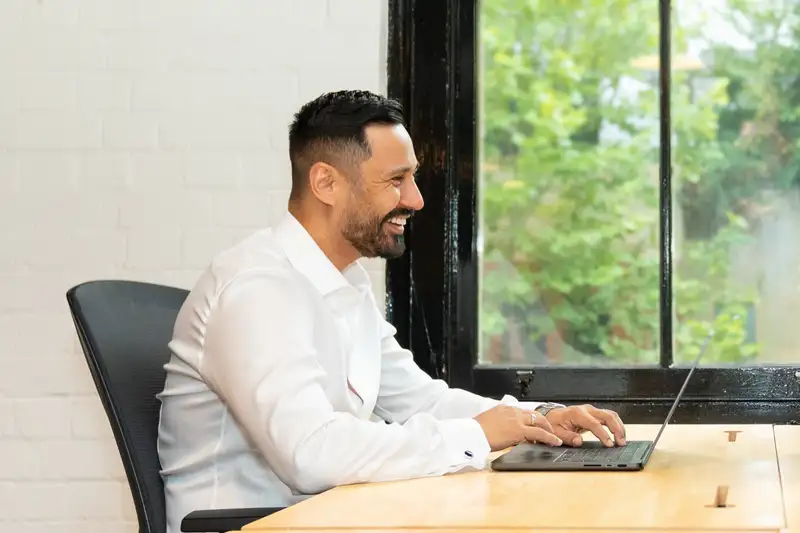 Marel Pencev, Tank Insurance founder, working at his laptop in the office
