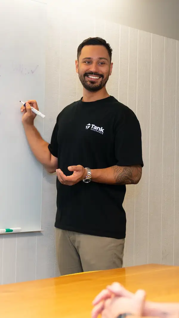 Marel Pencev presenting at a whiteboard in the Tank Insurance office