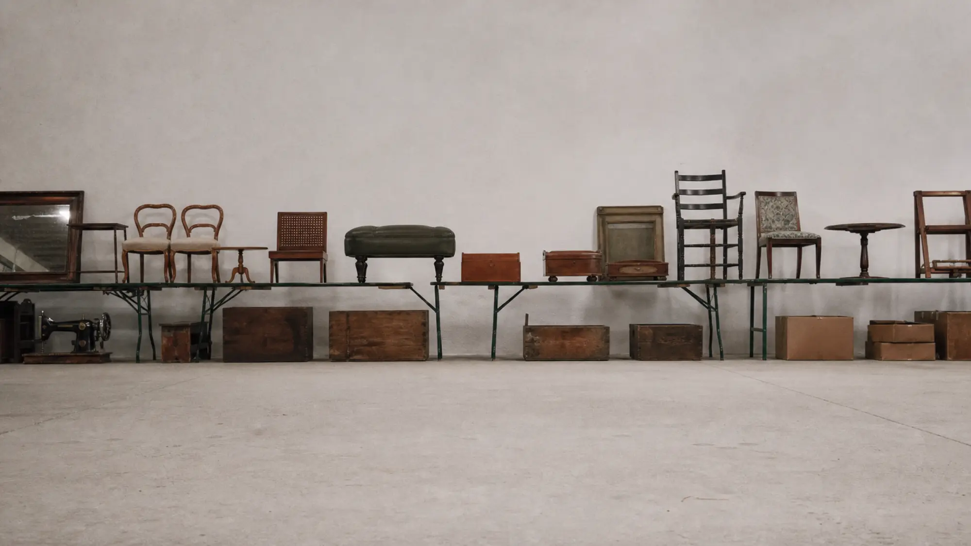 Trestle tables of auction lots along a saleroom wall, auctioneer professional indemnity quote