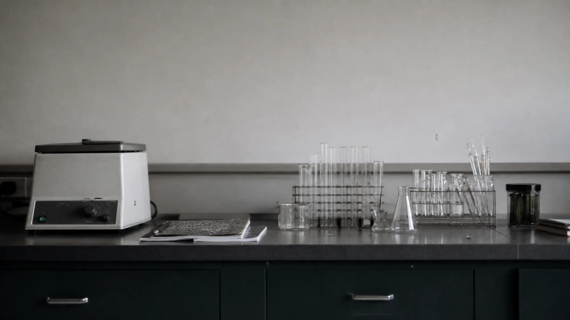 Centrifuge and glassware along a lab bench, biochemist professional indemnity insurance quote