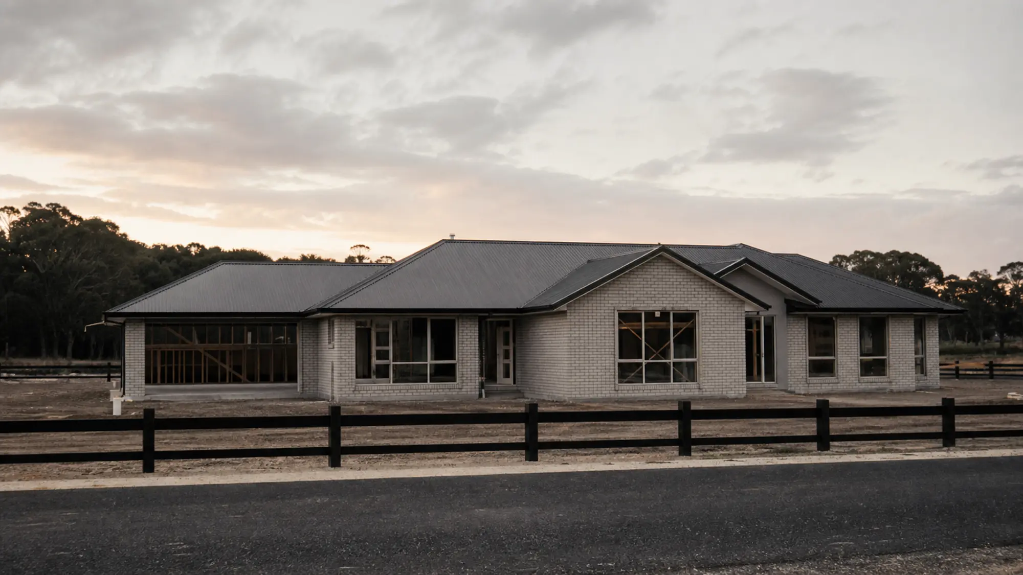 New home at lock-up stage in late light, building designer professional indemnity insurance quote