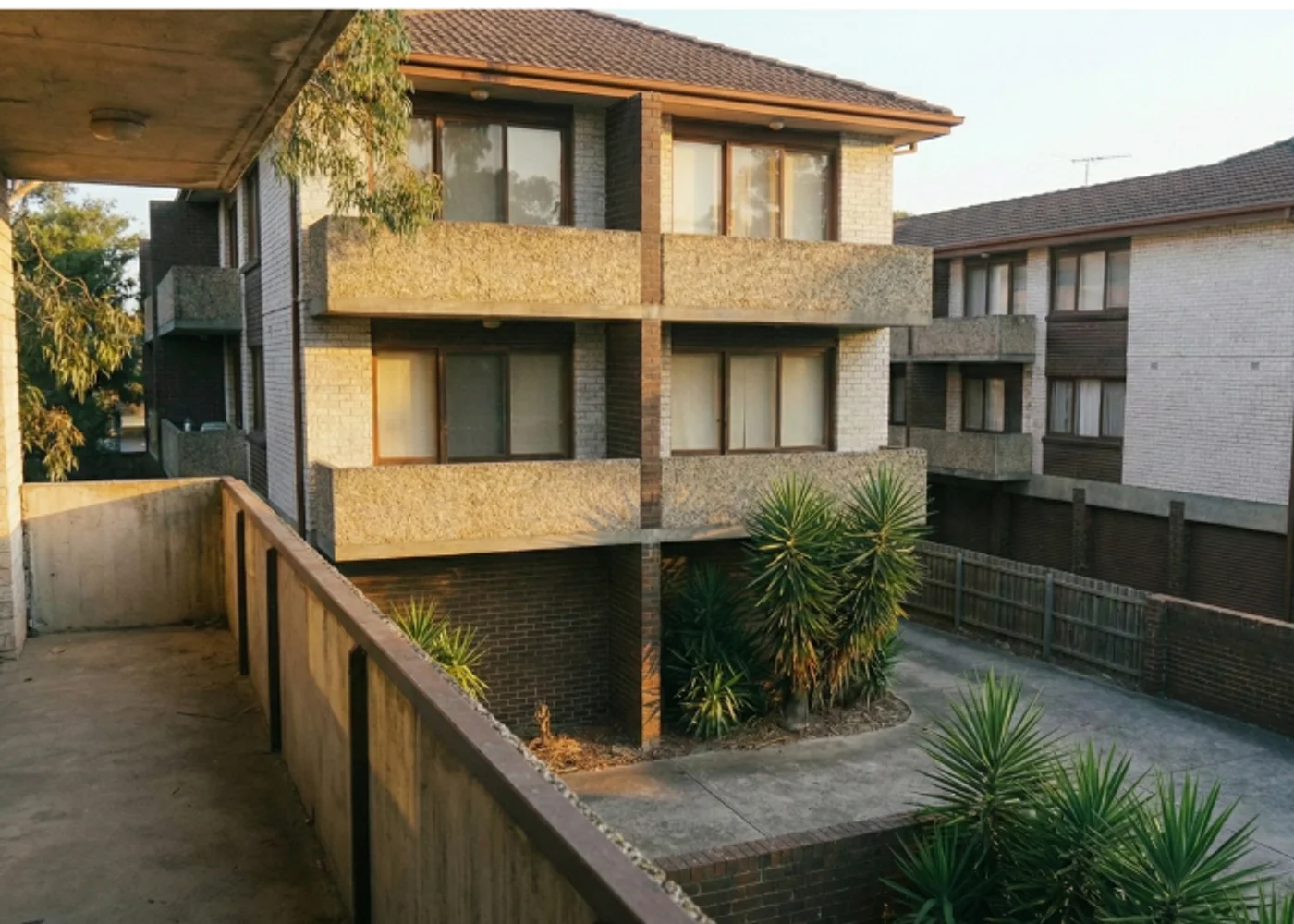 Close-up of building features including garages and balconies on a block of units, requiring accurate building sum insured.