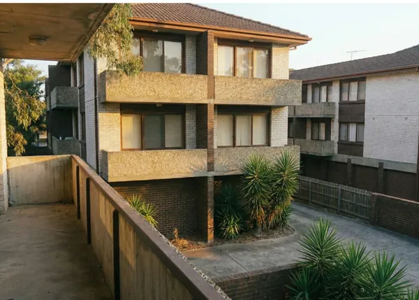 Close-up of building features including garages and balconies on a block of units, requiring accurate building sum insured.
