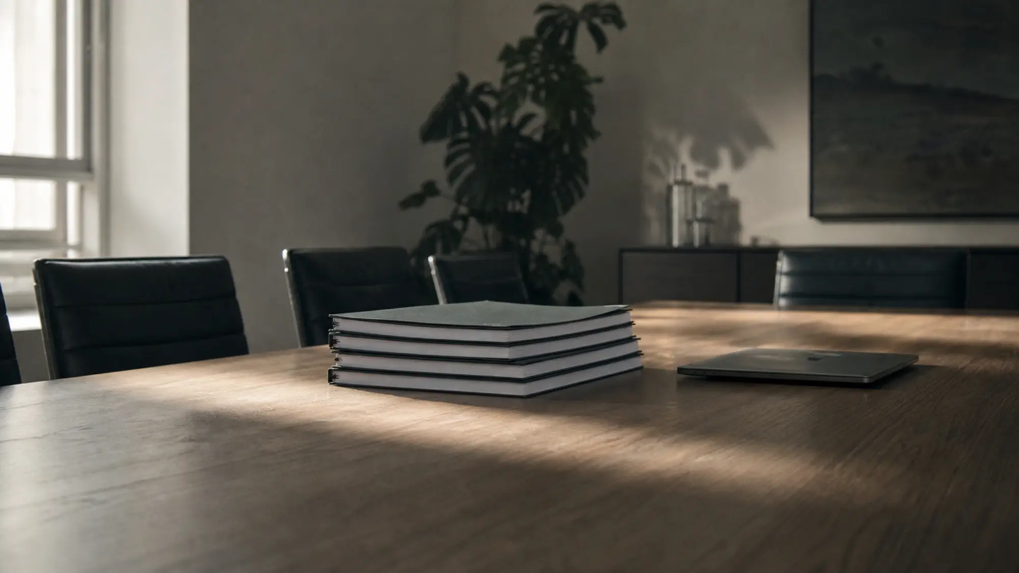 Bound valuation reports on a boardroom table, professional indemnity insurance for business valuers