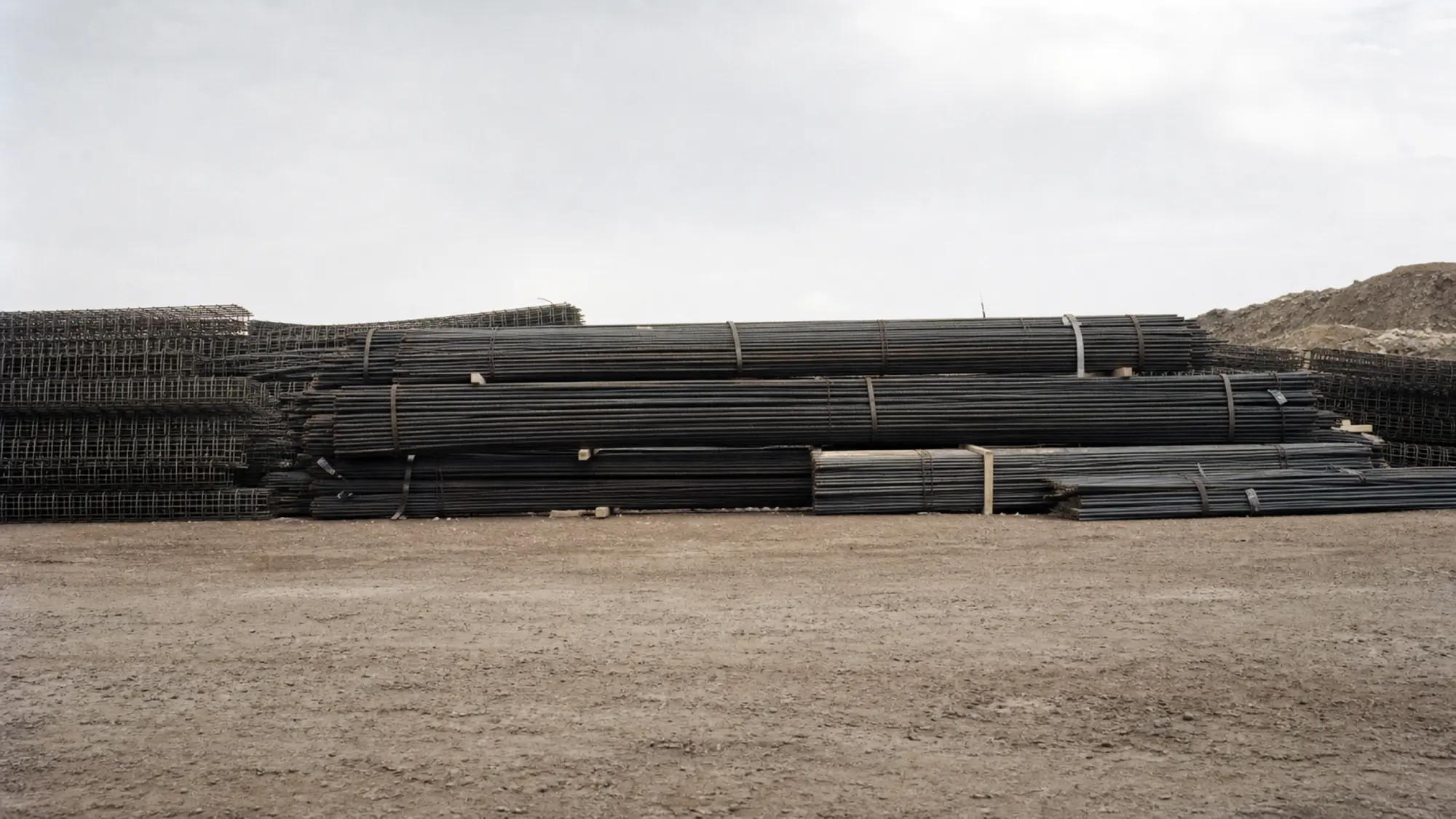 Bundled steel reinforcement at a building site - contract works insurance cost