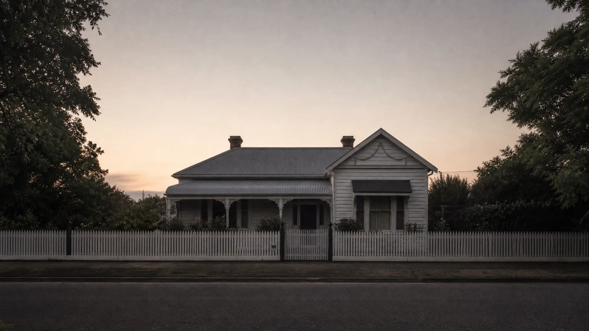 Unoccupied weatherboard estate home at dusk for deceased estate property insurance