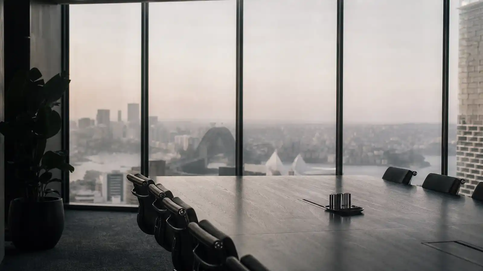 Empty boardroom overlooking a city skyline, where decisions covered by directors and officers insurance are made
