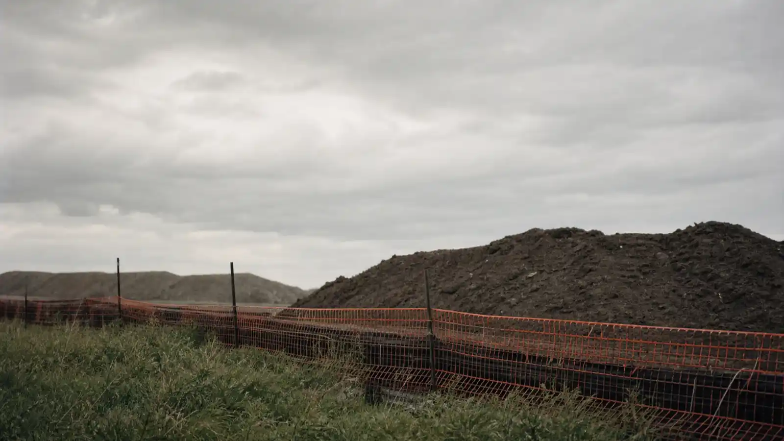Soil stockpiles and silt fencing on a site assessment, environmental consultant professional indemnity