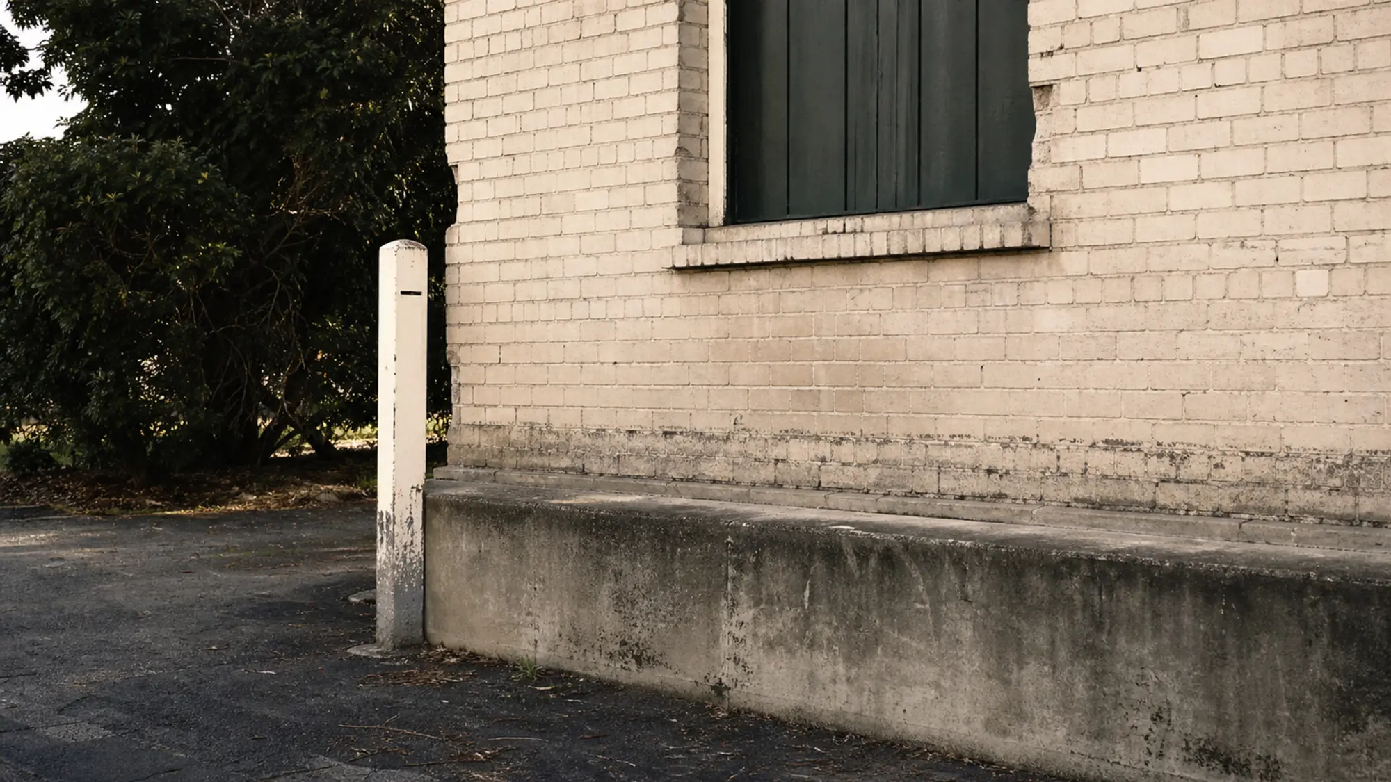 Brick building with a visible waterline after flooding for flood-zone landlord insurance
