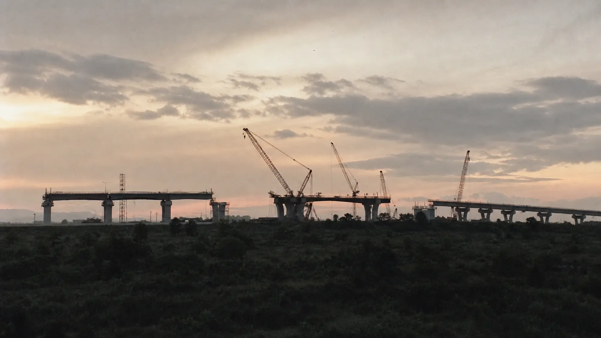 Freeway interchange under construction at dusk - insurance for civil engineering firms