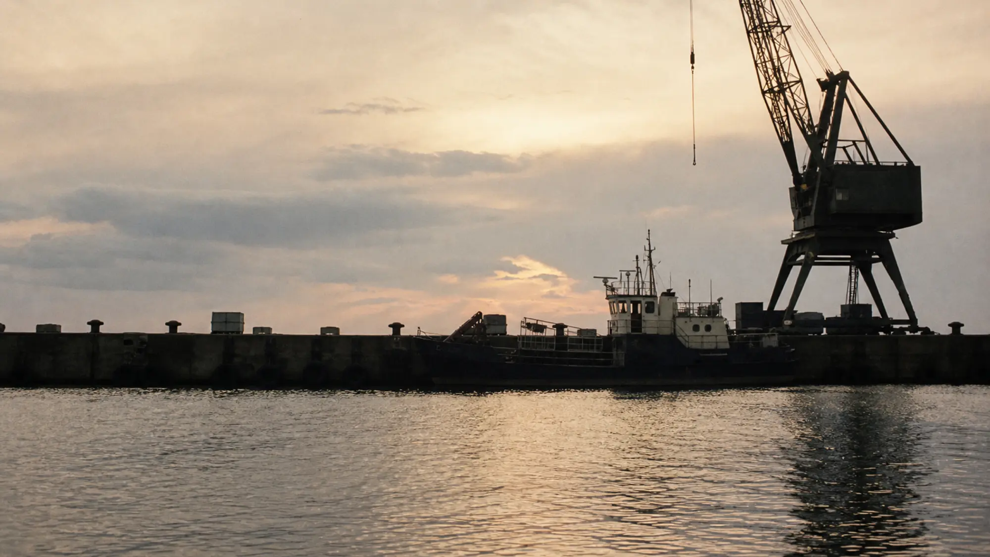 Working wharf and crane at dusk - insurance for marine engineering consultants
