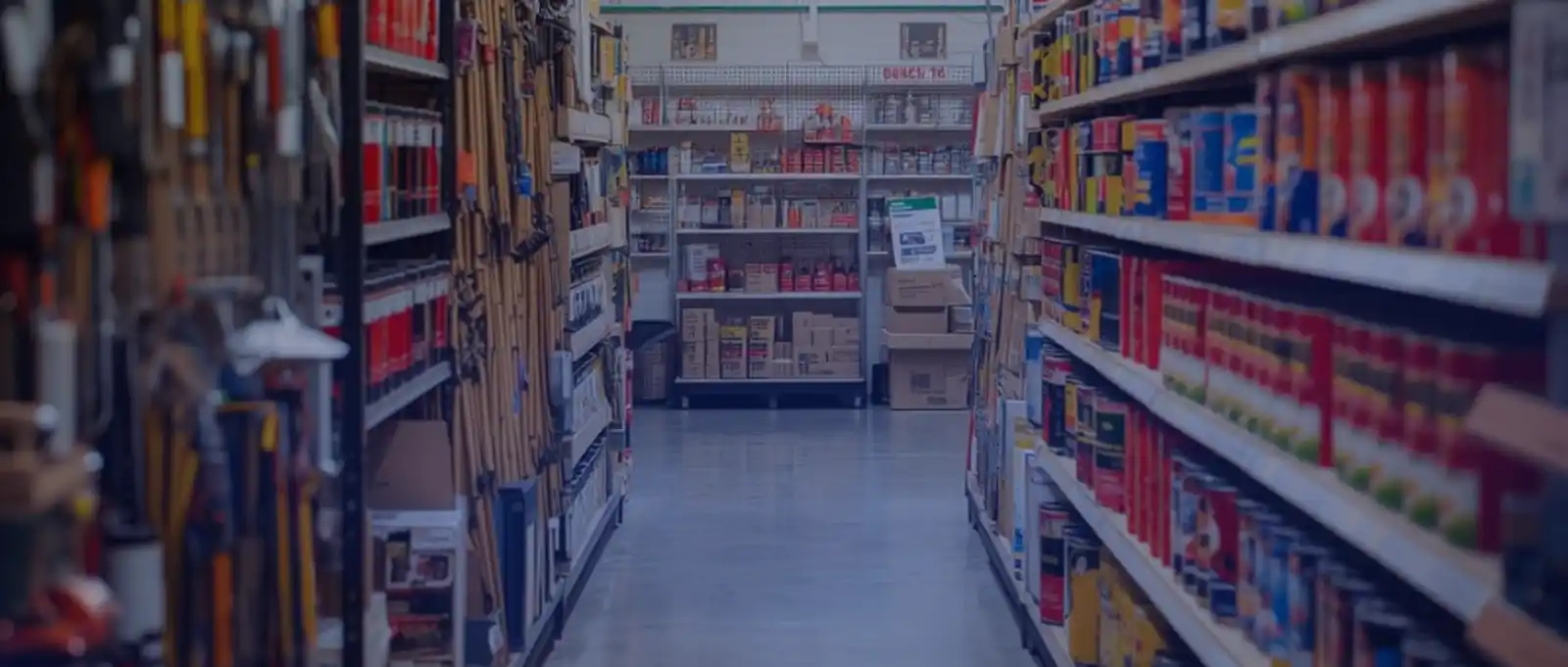 Trade counter and workshop area inside a hardware store filled with power tools, machinery, and industrial equipment requiring comprehensive asset protection insurance