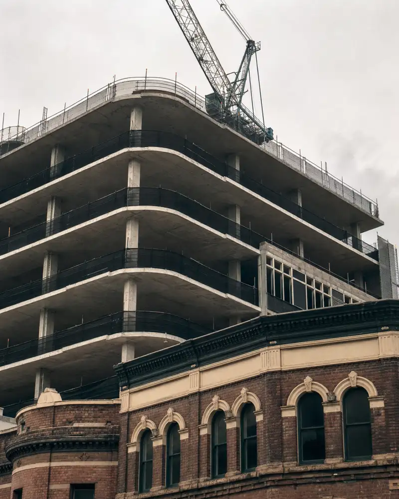 Office tower under construction beside a heritage shopfront in Parramatta's business district