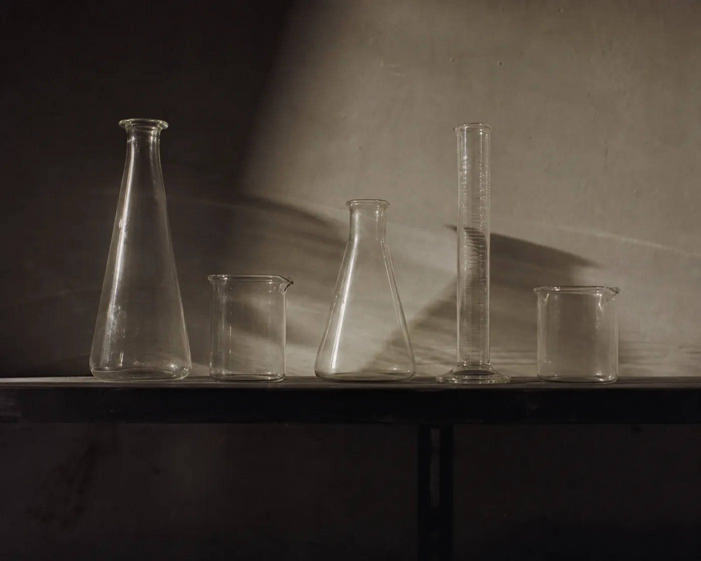 Laboratory glassware on a shelf, illustrating why insurers decline life sciences businesses