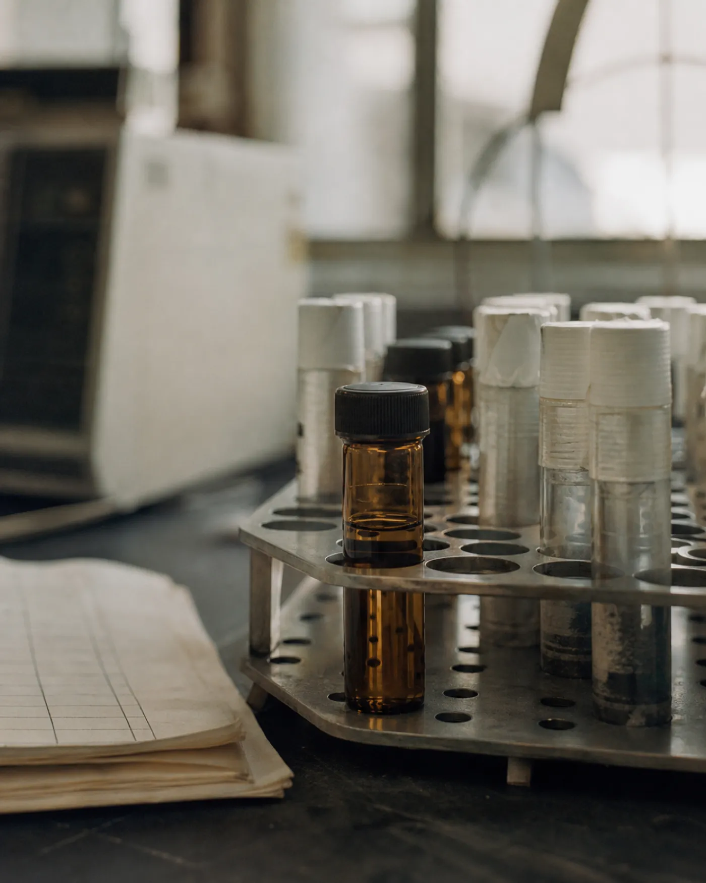 Amber sample vials in a laboratory rack, the products life sciences insurance covers
