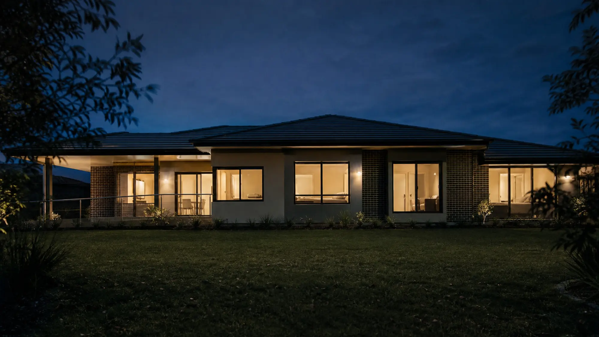 Accessible home with warmly lit windows at dusk for SDA fire safety insurance