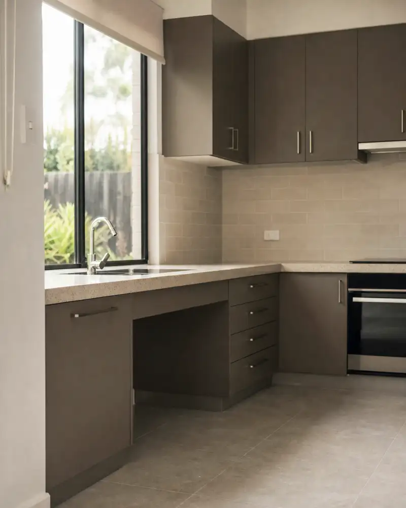 Accessible kitchen with lowered bench, knee clearance and lever tapware in an SDA home