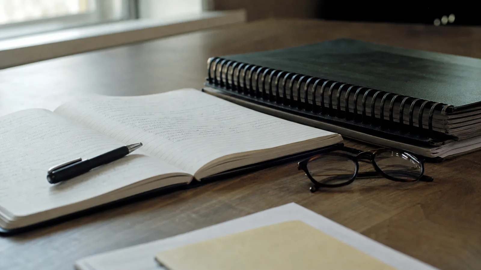 Minute book and by-laws folder on a desk, committee decisions covered by office bearers liability