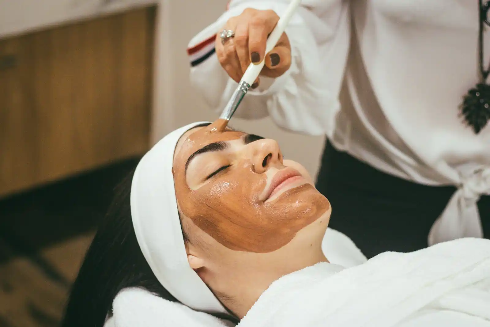 Beauty therapist performing a professional skincare consultation