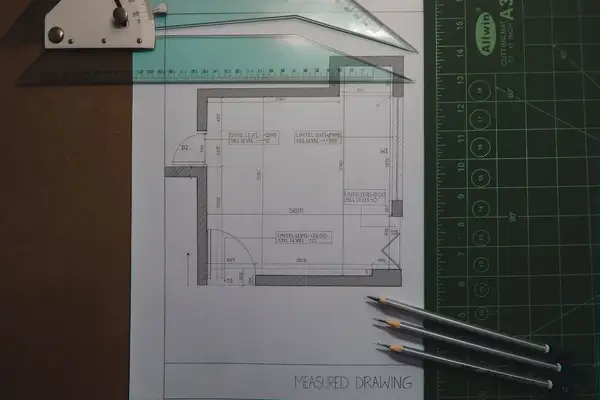 Technical construction drawing with drafting tools representing draftsperson PI coverage