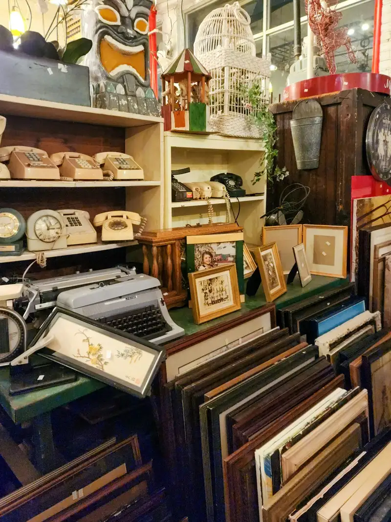 Auction lot display room with diverse items awaiting sale