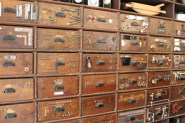 Antique drawers and hardware items on display at an auction house