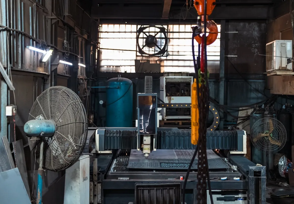CNC laser cutting machine inside an industrial metal fabrication workshop