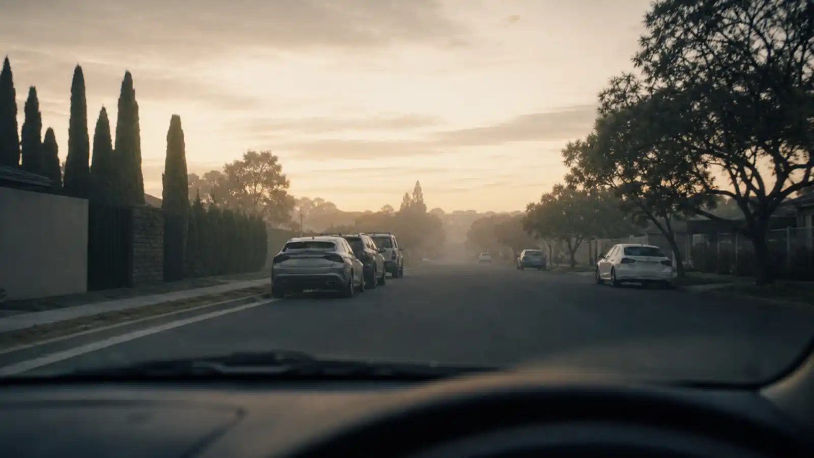 Suburban street at dawn from a parked car, surveillance work private investigator PI insurance covers