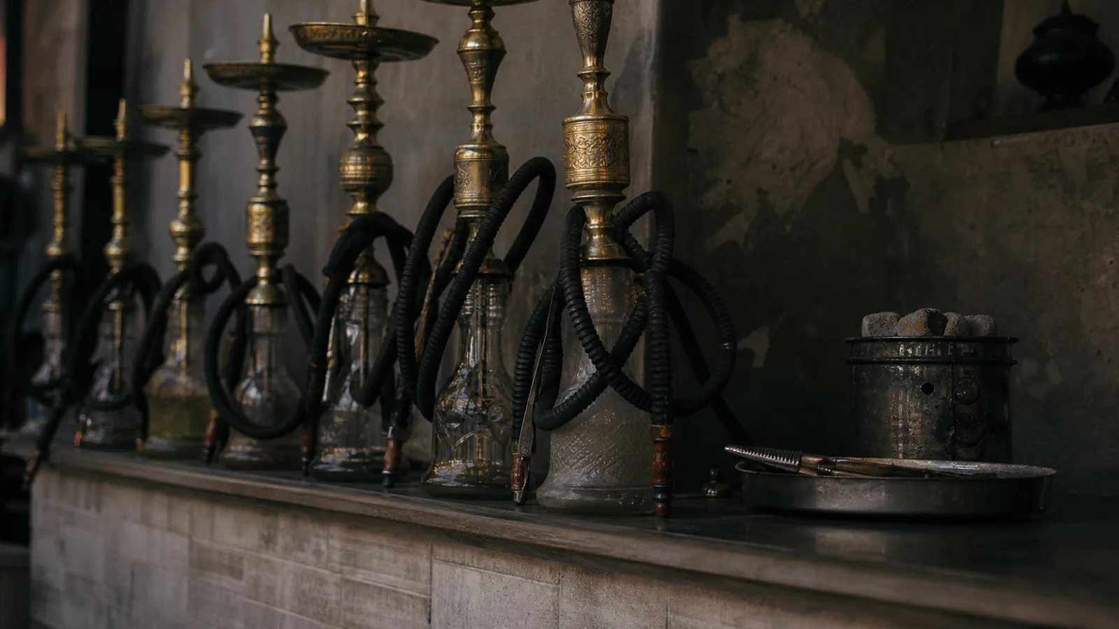 Waterpipes and charcoal equipment on a hookah cafe counter, the risks shisha insurance covers