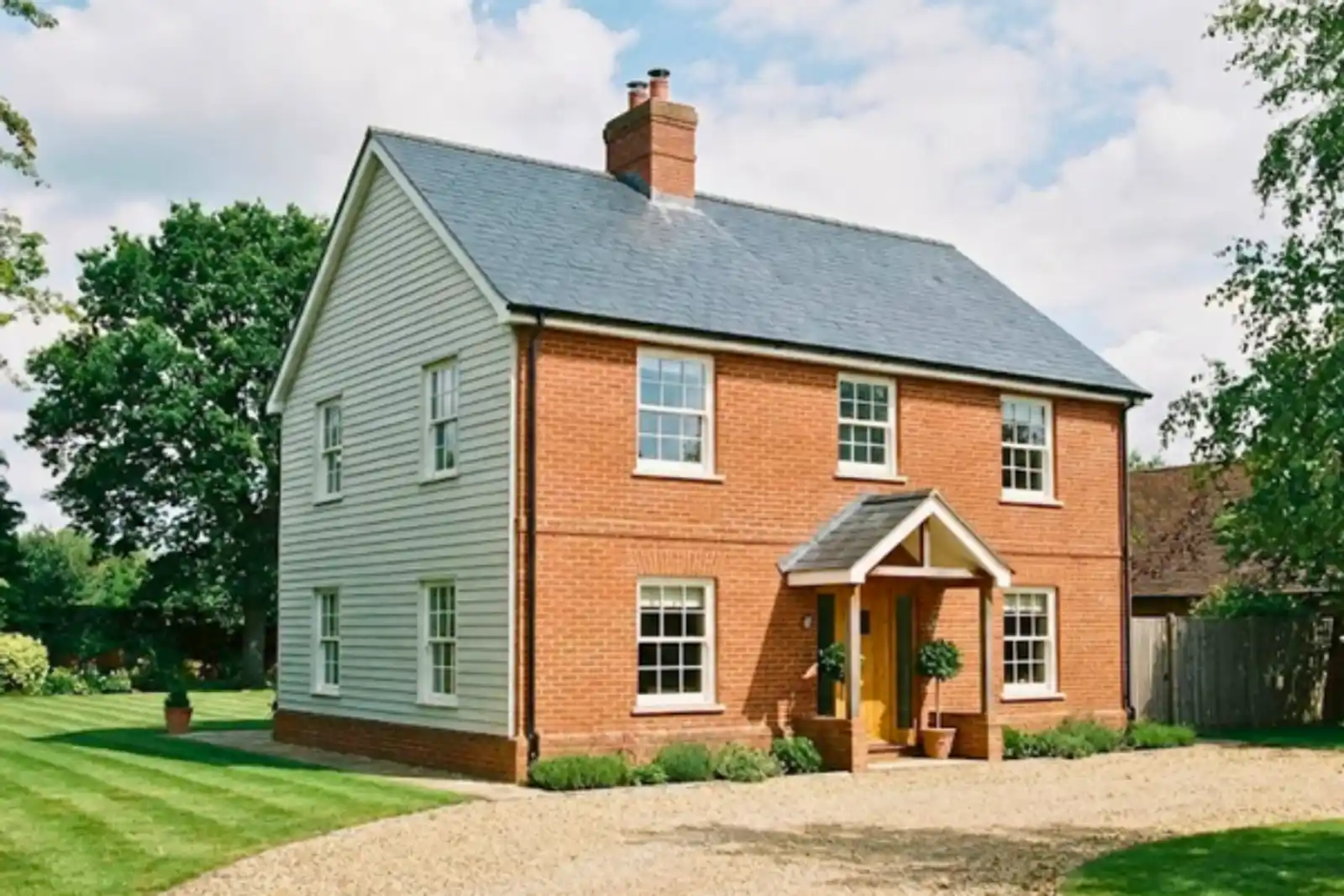 Two-storey brick and weatherboard house, a mixed-construction home whose rebuild cost drives its home insurance premium