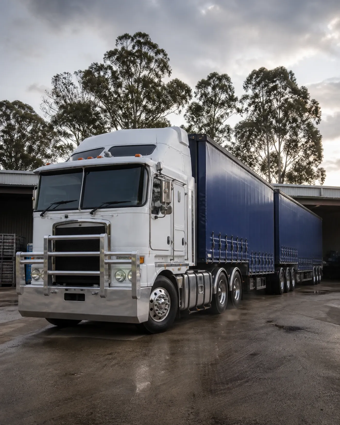 Australian cab-over prime mover and B-double trailers in a freight depot