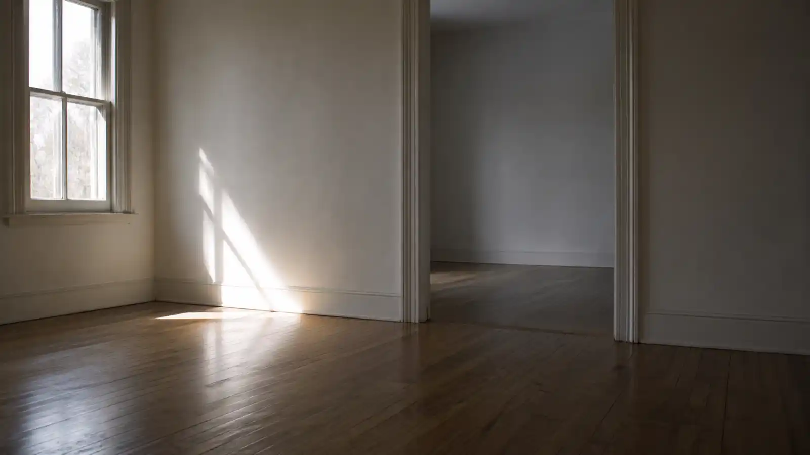 Empty unfurnished rental interior with timber floors for vacant property insurance