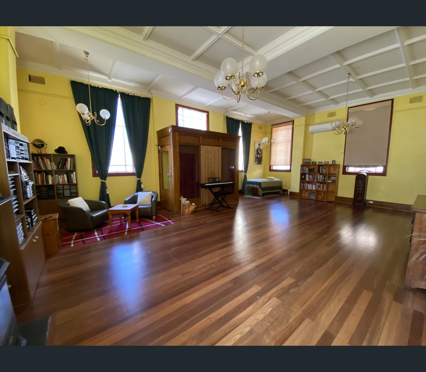 The interior of the heritage property showing coffered ceilings, original timber features, and polished hardwood floors
